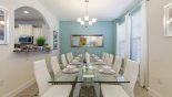 Villa rentals in Orlando, check out the Dining table with 10 comfortable chairs - arched opening to kitchen