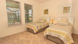 Ground floor bedroom #2 with twin beds & views onto pool deck with this Orlando Villa for rent direct from owner
