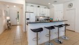 View of fully fitted kitchen and entrance hallway - breakfast island bar with 4 bar stools from Watersong Resort rental Villa direct from owner