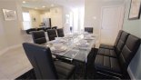 Villa rentals in Orlando, check out the Glass topped dining table with 8 comfortable leather chairs