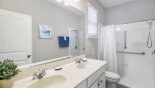 Accessible equipped ensuite bathroom with roll-in roll-out shower with fixed seat from Castillo 1 Villa for rent in Orlando