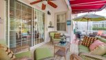 Covered lanai offering comfortable seating with ceiling fan from Highlands Reserve rental Villa direct from owner