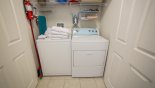 Laundry room with washer, dryer, iron & ironing board from Tall Palms 2 Townhouse for rent in Orlando
