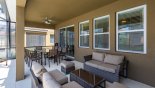 Villa rentals in Orlando, check out the Covered lanai with patio table & 10 chairs plus rattan seating area