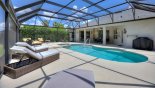 Extended pool deck viewed toward shady lanai with this Orlando Villa for rent direct from owner