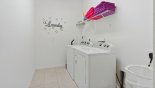 Laundry room with washer, dryer, iron & ironing board - www.iwantavilla.com is the best in Orlando vacation Villa rentals