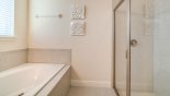 Master #1 ensuite bathroom showing bath & walk-in shower - www.iwantavilla.com is the best in Orlando vacation Villa rentals