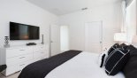 Master bedroom #1 with large wall mounted LCD TV with this Orlando Villa for rent direct from owner