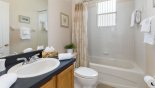 Family bathroom shared by twin bedrooms with bath and shower over with this Orlando Villa for rent direct from owner