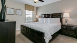 Bedroom #6 with king sized bed & views onto pool deck - www.iwantavilla.com is the best in Orlando vacation Villa rentals