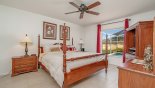 Spacious rental Highlands Reserve Villa in Orlando complete with stunning Master bedroom #1 with king sized bed, matching nightstands and stunning views over the deck and pool