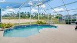 View of north east facing sun drenched pool and expansive extended deck with this Orlando Villa for rent direct from owner