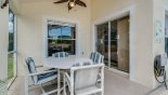 Villa rentals in Orlando, check out the View of the covered lanai with comfortable seating for 4 and access to the family room