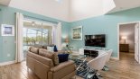 View of family room with ample comfortable seating enjoying views & access onto pool deck with this Orlando Villa for rent direct from owner