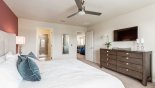 Master bedroom #1 with wall mounted LCD cable TV - viewed towards ensuite bathroom with this Orlando Townhouse for rent direct from owner