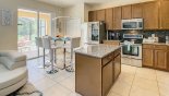 Kitchen viewed towards breakfast nook with high table with 6 bar stools from Queen Palm 3 Villa for rent in Orlando
