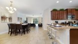 Spacious rental Solterra Resort Villa in Orlando complete with stunning View as you enter villa with kitchen to right and open plan dining and family room beyond