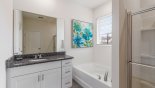 Ground floor master #1 ensuite bathroom with Roman bath, single sink, walk-in shower & separate WC with this Orlando Villa for rent direct from owner