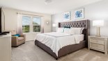 Townhouse rentals in Orlando, check out the Master bedroom #1 with king sized bed & views over pool deck & lake beyond
