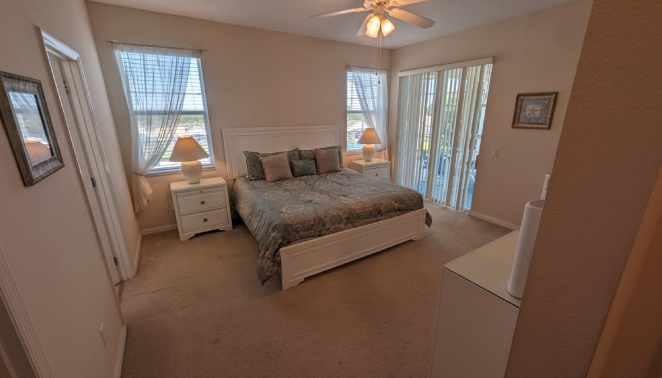 Master #1 bedroom with king sized bed and private access & views onto pool deck