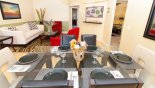 Villa rentals in Orlando, check out the Dining area with glass-topped dining table and 6 chairs - living room to rear