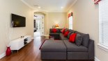 Villa rentals in Orlando, check out the Entertainment loft area with large wall-mounted LCD cable TV and sectional sofa set