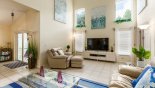 Villa rentals in Orlando, check out the Cathedral ceiling with high level windows give feeling a space  - patio doors to left lead onto pool deck