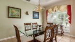 Dining room with large glass-topped dining table & 6 chairs - views onto front garden from Highlands Reserve rental Villa direct from owner