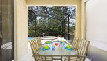 Villa rentals in Orlando, check out the Patio table under shady lanai with ceiling fan - ideal for alfresco dining