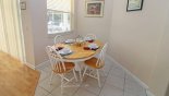 Breakfast nook adjacent to family room with seating for 4 and views onto pool deck from Highlands Reserve rental Villa direct from owner