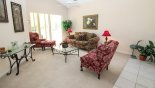 Living room with direct access onto pool deck via covered lanai with this Orlando Villa for rent direct from owner