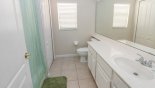 Family bathroom #3 with bath & shower over, single vanity sink & WC with this Orlando Villa for rent direct from owner