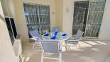 Covered lanai with patio table & 4 chairs - chairs from deck can be used to increase seating to 6 from Cambridge 4 Villa for rent in Orlando