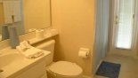 Master ensuite bathroom #2 with walk-in shower, single sink & WC - also serves as pool bathroom with this Orlando Villa for rent direct from owner