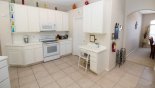 Fully fitted kitchen with quality appliances and Corian counter tops - access to dining room on right with this Orlando Villa for rent direct from owner