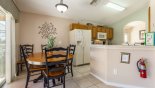 Villa rentals in Orlando, check out the Breakfast nook adjacent to kitchen with seating for 4 +2 and views onto pool deck