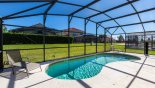 Spacious rental Solana Resort Villa in Orlando complete with stunning Pool deck includes a stowable pool safety fence visible on far end of pool cage & mounting holes in deck