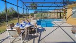 Pool deck with patio table & 4 chairs - www.iwantavilla.com is the best in Orlando vacation Villa rentals