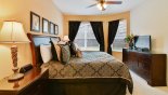 Villa rentals near Disney direct with owner, check out the Master bedroom #1 with king-sized bed, LCD cable TV & views onto pool deck