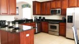 Fully fitted luxury kitchen with marble countertops and stainless steel appliances with this Orlando Villa for rent direct from owner