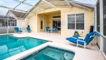 Spacious rental Highlands Reserve Villa in Orlando complete with stunning View from spa towards covered lanai with round patio table & 4 chairs