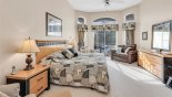 Master bedroom with king sized bed & views & private access onto pool deck with this Orlando Villa for rent direct from owner