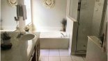 Master ensuite bathroom with bath, walk-in shower & his 'n' hers sinks & WC - www.iwantavilla.com is the best in Orlando vacation Villa rentals