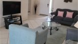 Living room with comfortable seating and large LCD cable TV with this Orlando Villa for rent direct from owner