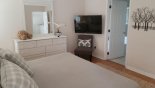 Master bedroom with wall mounted LCD cable TV - www.iwantavilla.com is the best in Orlando vacation Villa rentals