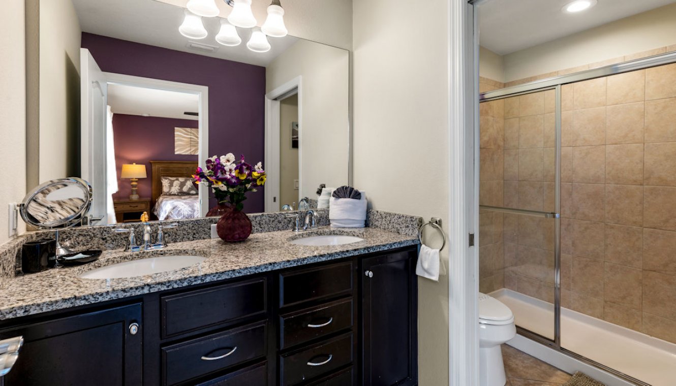 Master ensuite bathroom #2 with his & hers sinks and separate walk-in shower with WC