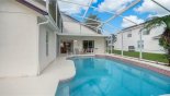 Spacious rental Lindfields Villa in Orlando complete with stunning View of pool towards covered lanai with additional chairs