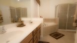 Master 1 ensuite bathroom with bath, large walk-in shower, WC & his & hers sinks from Queen Palm 2 Villa for rent in Orlando