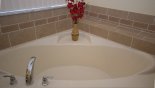 Master 1 ensuite corner bath - www.iwantavilla.com is your first choice of Villa rentals in Orlando direct with owner