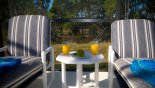 Small tables are ideal for putting your cold drink on whilst sunbathing from Queen Palm 2 Villa for rent in Orlando